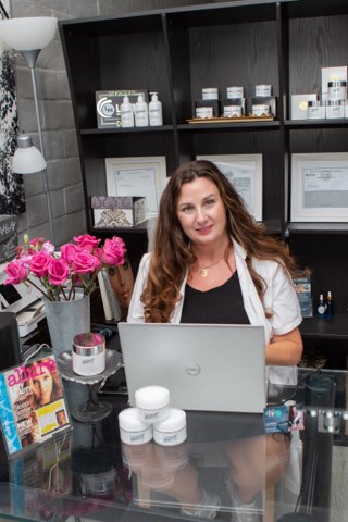 Holistic esthetician Leslie Morand with hormone-safe natural skincare products in Solana Beach, California