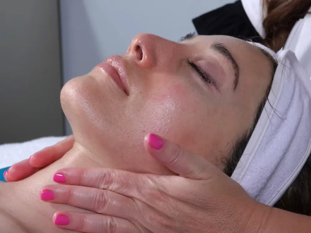 Holistic esthetician Leslie Morand with natural skincare products for rosacea and sensitive skin in Solana Beach, California